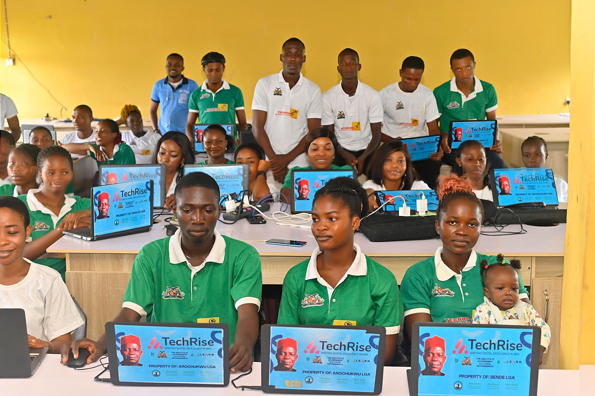 Rows of trainees at laptops in a community training centre